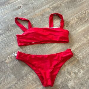 Wahines red women’s two piece. The Top is a M and the bottom is L.